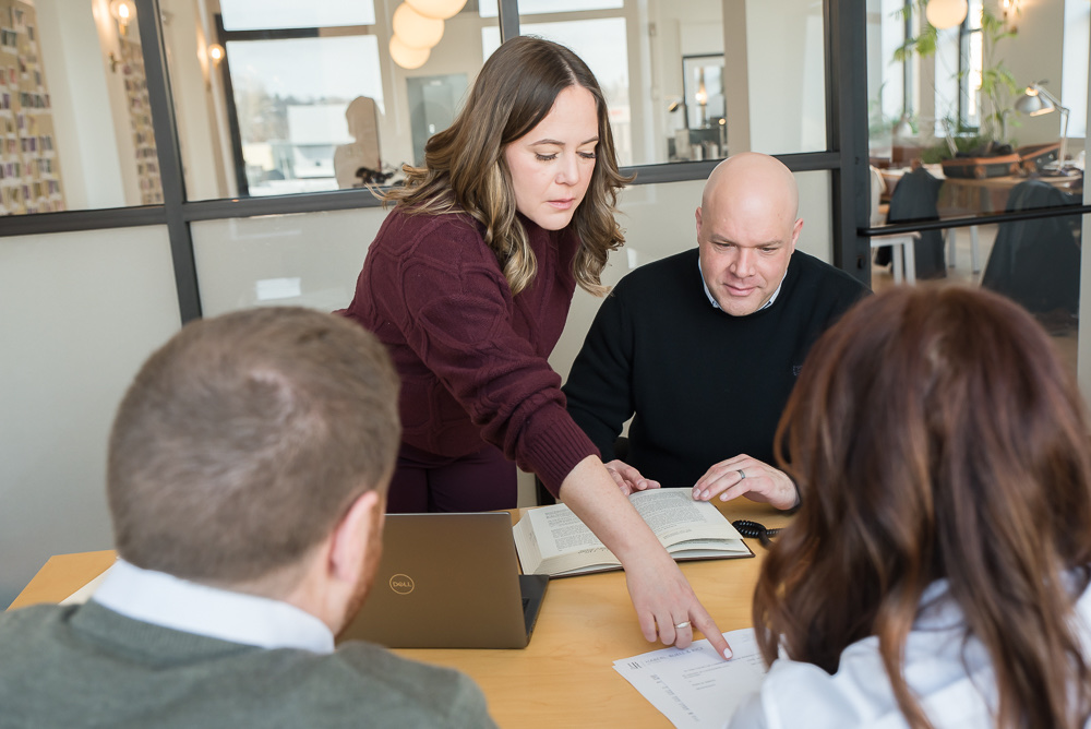 The Complete Closings team reviewing documents at the closing table